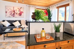a living room with a counter with glasses on it at Maison d'Hortense - Chalet le Renard in Hérémence