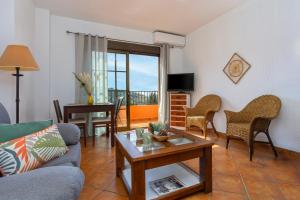 a living room with a couch and a table at Hotel Rural Sierra Tejeda in Alcaucín
