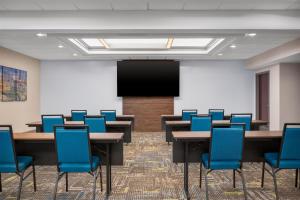 a conference room with tables and chairs and a screen at Hampton Inn & Suites Charlotte Arrowood Rd in Charlotte +32 photos