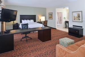 a hotel room with a bed and a desk at Hampton Inn Pecos in Pecos