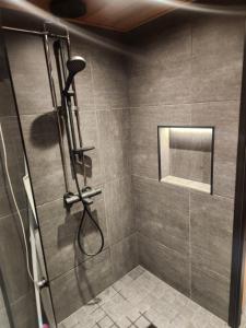 a shower with a shower head in a bathroom at Pytkynkulma in Syöte +7 photos
