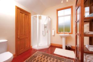 a bathroom with a shower and a toilet and a sink at Seaport Village in Russell +115 photos