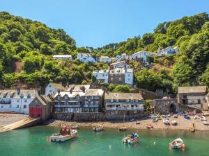 a town on a hill with boats in the water at 4 Bed in Bideford oc-owlbr in Clovelly