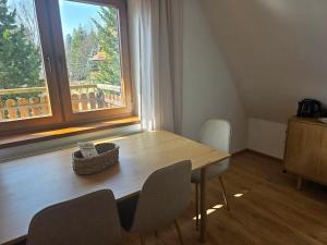 a table and chairs in a room with a window at La Kozica in Kościelisko