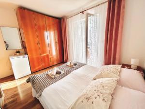 a bedroom with a bed and a large window at room MLIN 2 in Jakišnica