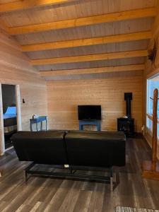 a living room with a large bed and a tv at Terrawoods Pine Cottage in Parry Sound