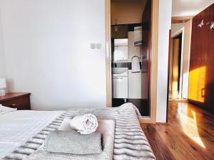 a bedroom with a bed with two towels on it at room MLIN 2 in Jakišnica