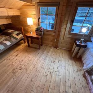 a bedroom with a bed and a table with a lamp at Terrawoods Pine Cottage in Parry Sound