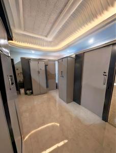 an empty room with lockers and a ceiling at Your Home In Riyadh Hostel in Riyadh