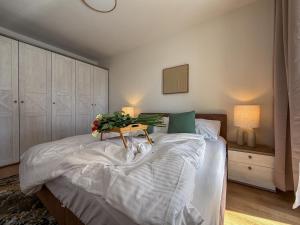a bedroom with a bed with a table with flowers on it at The Elegant Hideaway in Šurany