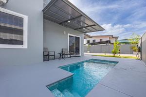 a swimming pool in the backyard of a house at Casamar in Uvita