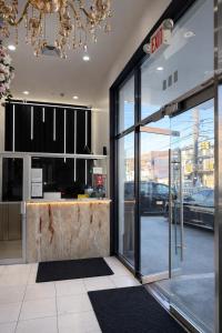 a lobby of a store with a large glass door at Grandview Hotel New York in Queens