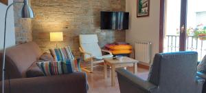 a living room with a couch and a table at Casa Rural Maria in Molinaseca