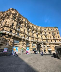 a large building with people walking in front of it at Due Monelli in Naples