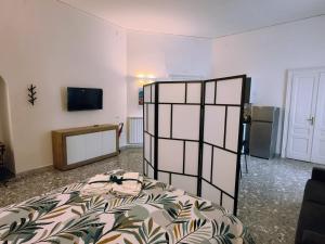 a bedroom with a bed and a tv on a wall at Due Monelli in Naples
