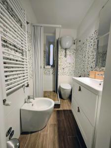a white bathroom with a sink and a toilet at Due Monelli in Naples +48 photos