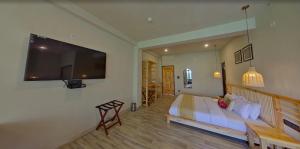 a bedroom with a bed and a flat screen tv at Sand Dunes Retreat in Leh