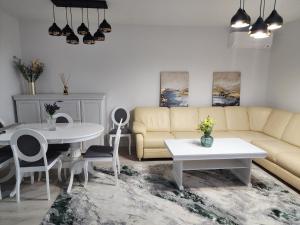 a living room with a couch and a table at Luxury apartment Avanera in Suceava
