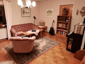 a living room with a couch and a table at The Sheep Inn B&B in Arvika