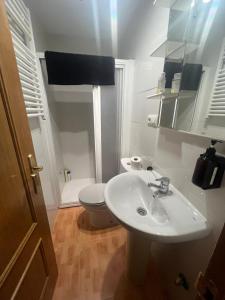 a bathroom with a white sink and a toilet at La Morada del Jucar in Cuenca +8 photos