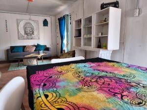 a room with a bed with a colorful blanket at Luna Atacama in San Pedro de Atacama