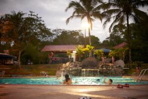 a group of people in a pool at a resort at Hostería Ojo de Agua in Loreto