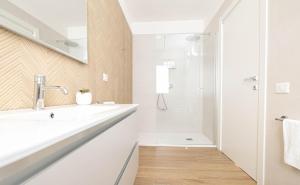 a white bathroom with a sink and a shower at Corona Guest House in Sestu +17 photos