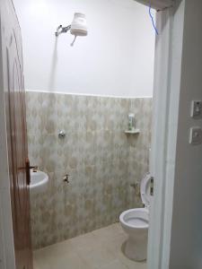a bathroom with a toilet and a sink at Jjhomes in Eldoret
