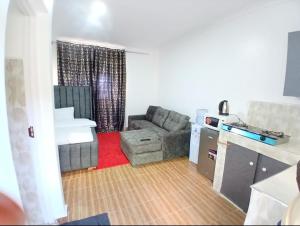 a living room with a couch and a table at Jjhomes in Eldoret
