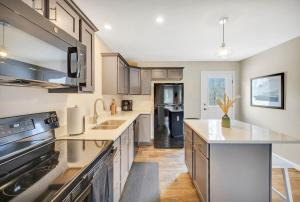 a large kitchen with a sink and a stove at Coastal Maine Escape in Ellsworth