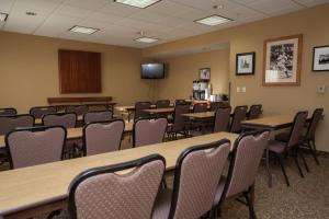 a conference room with tables and chairs and a screen at Hampton Inn Oneonta in Oneonta