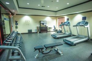 a gym with treadmills and machines in a room at Hampton Inn & Suites Palestine in Palestine +5 photos