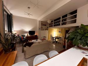 a living room with a couch and a table at Comme à la Maison - Terrasse et Jardinet- in Douarnenez