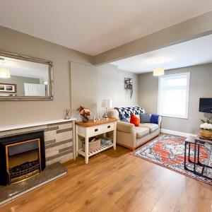 a living room with a fireplace and a couch at killarney Townhouse with super location in Killarney