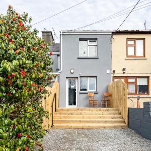 a house with a wooden staircase in front of it at killarney Townhouse with super location in Killarney