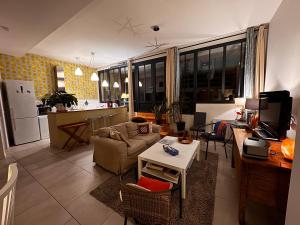 a living room with a couch and a table at Comme à la Maison - Terrasse et Jardinet- in Douarnenez