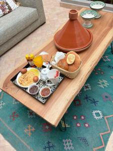 a tray of breakfast food on a table at Hôtel Riad La Nouvelle Etoile - Agadir in Agadir +23 photos