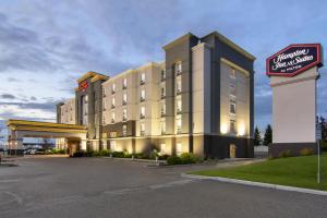 a hotel building with a sign in front of it at Hampton Inn & Suites Edmonton/West in Edmonton