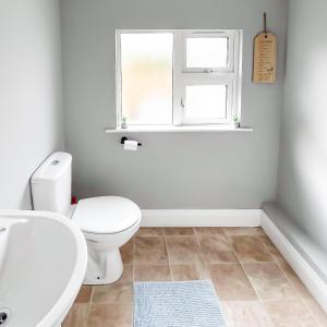 a bathroom with a white toilet and a window at killarney Townhouse with super location in Killarney +34 photos