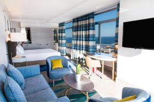 a hotel room with a bed and a large window at Hilton Diagonal Mar Barcelona in Barcelona