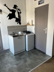 a small kitchen with a sink and a stove at Studio à 350m de la gare in Tours +4 photos