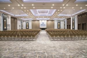 an empty banquet hall with chairs and a stage at Hilton Diagonal Mar Barcelona in Barcelona +191 photos