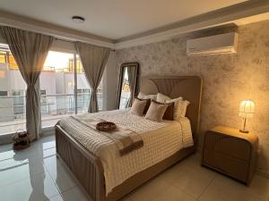 a bedroom with a bed and a large window at Baja Ocean View 3 BR Panoramic Terrace & Private Jacuzzi 8pp in Rosarito +28 photos