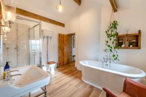 a large bathroom with a tub and a sink at 4 Bed in Cowling oc-h30773 in Cowling +54 photos