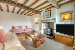 a living room with a couch and a fireplace at 4 Bed in Cowling oc-h30773 in Cowling