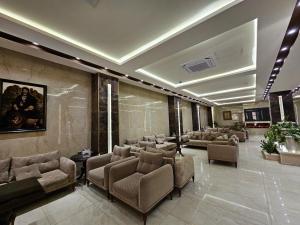 a lobby with couches and chairs in a building at Al-Mahasen Hotel in An Najaf