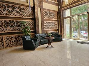 a lobby with couches and a table in a building at Al-Mahasen Hotel in An Najaf