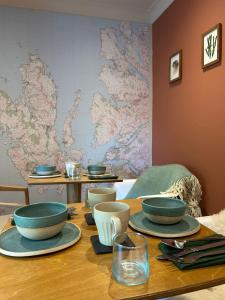 a table with bowls and plates on top of it at Clachamish House in Portree