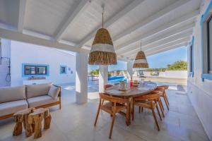a dining room with a table and a couch at Vista Azul by Vintage Travel in Loulé