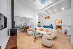 a living room with two couches and a fireplace at Vista Azul by Vintage Travel in Loulé